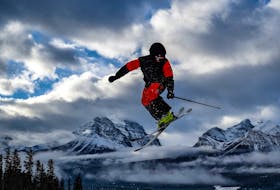A skier floats above the clouds after hitting one of the many jumps in the Boulevard Terrain Park at Lake Louise Ski Resort.