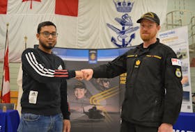 Petty officer second class David MacPherson, right, welcomes Sufian Chowdhury into the Royal Canadian Navy at the HMCS Queen Charlotte in Charlottetown on March 8. Chowdhury is the first permanent residence in Atlantic Canada to join the navy since the Canadian Armed Forces changed its policy regarding permanent residents in November 2022. Dave Stewart • The Guardian