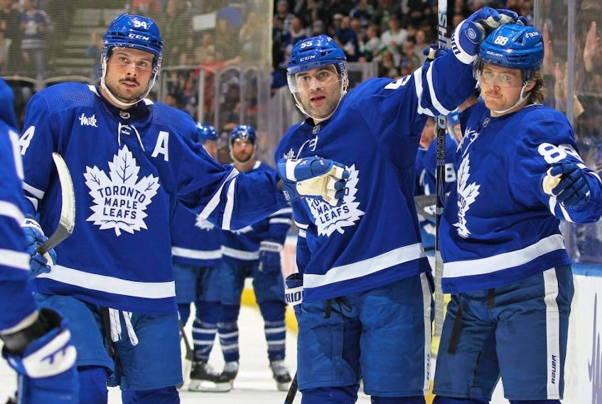 Maple Leafs forward William Nylander, right, celebrates a goal against the Oilers with teammates Austin Matthews, left, and Mark Giordano, centre, during NHL action at Scotiabank Arena in Toronto, Saturday, March 11, 2023.