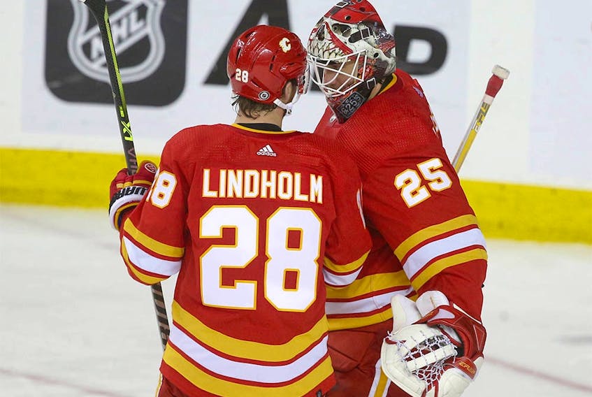  Elias Lindholm congratulates goalie Jacob Markstrom on the victory during NHL action between the New York Islanders and the Calgary Flames in Calgary on Friday, January 6, 2023.