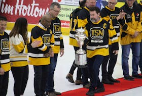 Team captain Brian Melanson carried the Allan Cup down the red carpet to share with his former teammates.