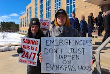 Brittany Whitten (left) and Michael Agate attended the protest at Confederation Building on March 14. Agate, who is from Whitbourne but now lives in Kilbride, said he doesn't want people to die because they don't have emergency services in the area anymore. Andrew Waterman/The Telegram