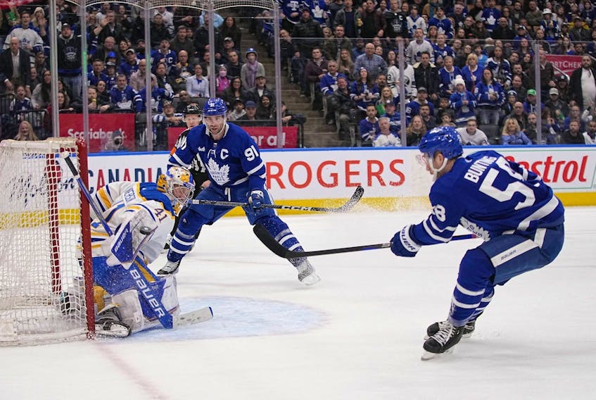 Buffalo Sabres goaltender Craig Anderson (41) and Toronto Maple Leafs forward John Tavares (91) watch a shot by  forward Michael Bunting (58) go wide of the net during the third period at Scotiabank Arena March 13, 2023.  