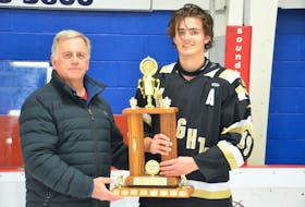 Charlottetown Bulk Carriers Knights forward Jonah MacDonald, right, accepts the most-valuable-player award for the provincial major under-18 male hockey league playoffs. Barry Thompson, president of the New Brunswick/P.E.I. Major Under-18 Hockey League playoffs, presented the award following the Knights’ 7-6 overtime win over the host Kensington Monaghan Farms Wild on March 13. Jason Simmonds • The Guardian