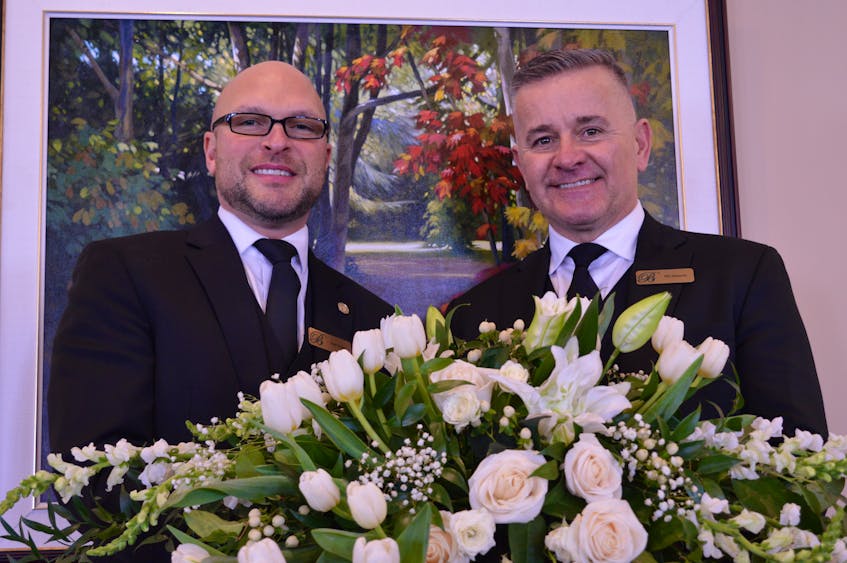 Paul Daigle, left, and Bill Sampson move a spray of flowers after a funeral service at Belvedere Funeral Home on March 1. The pair took over the business at the request of former owner Faye Doucette in October 2022. Alison Jenkins • The Guardian