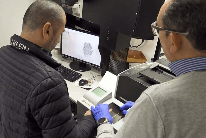  Domenico Cugliari gets fingerprinted at the airport in Rome. 