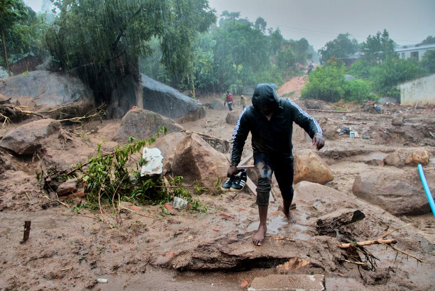 A man walks away from buildings damaged by Cyclone Freddy in Chilobwe, Blantyre, Malawi, March 13, 2023. REUTERS/Eldson Chagara.  A man walks away from buildings damaged by Cyclone Freddy in Chilobwe, Blantyre, Malawi on March 13. After making landfall in Mozambique already, the storm went back out to see, regained strength and struck Mozambique a second time and also made landfall in neighbouring Malawi. REUTERS/Eldson Chagara