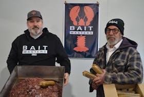 Wally MacPhee, left, and Mark Prevost, right, co-owners of Bait Masters Inc., are testing out the use of grey seal meat in their alternative lobster and crab bait. Prevost says interest in the product has surpassed any of their other baits. Dave Stewart • The Guardian