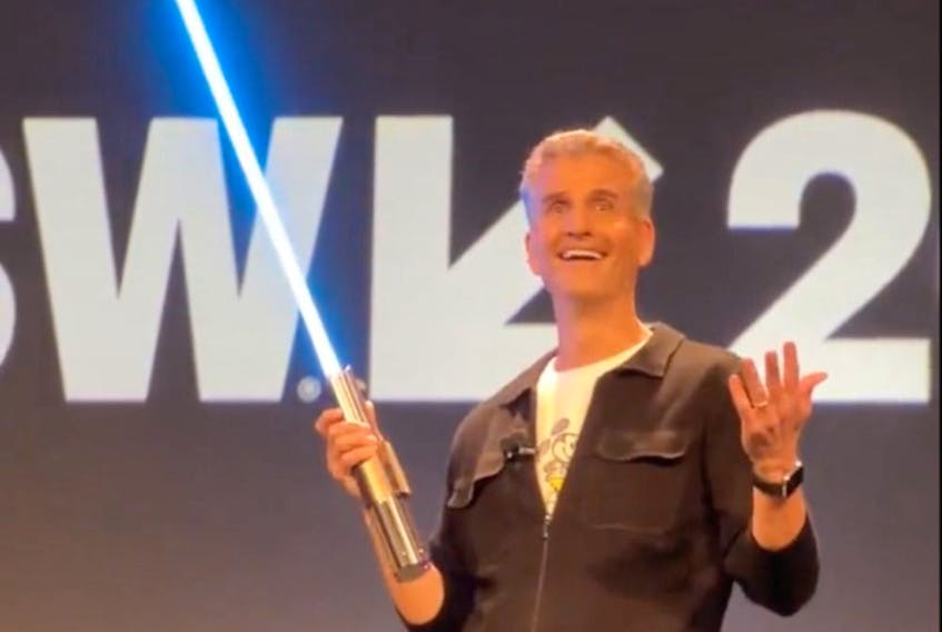 Disney Parks and Experiences Chairman Josh D’Amaro shows off a 'real' lightsaber.
