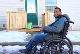 Antwaun Rolle, who lives with cerebral palsy, sits beside the doorway to his apartment near UPEI. Rolle faces numerous mobility and accessibility challenges every morning on his way to school, starting with getting out his front door. - Logan MacLean