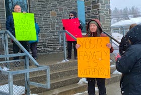 Ashleigh Long held a sign to let her brother, Evan Long, know his family supports him while waiting outside the Corner Brook courthouse on Thursday, March 16. - Diane Crocker/SaltWire Network