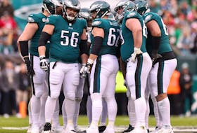 Isaac Seumalo #56, Jason Kelce (62) and Landon Dickerson (69) of the Philadelphia Eagles huddle with their teammates against the San Francisco 49ers during the first quarter in the NFC Championship Game at Lincoln Financial Field on Jan. 29, 2023 in Philadelphia, Pa.