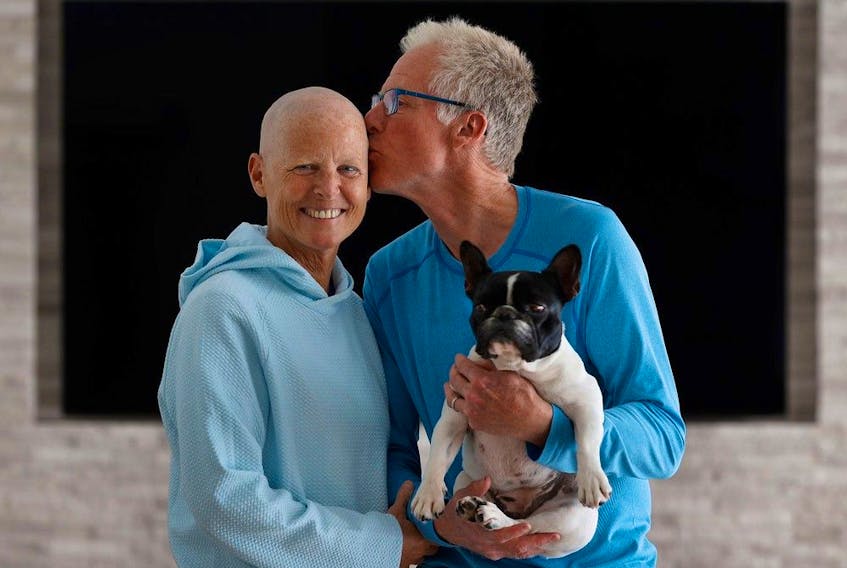 Sindy Hooper, shown here with husband, Jonathan, and their dog Lexey, has stage IV pancreatic cancer.