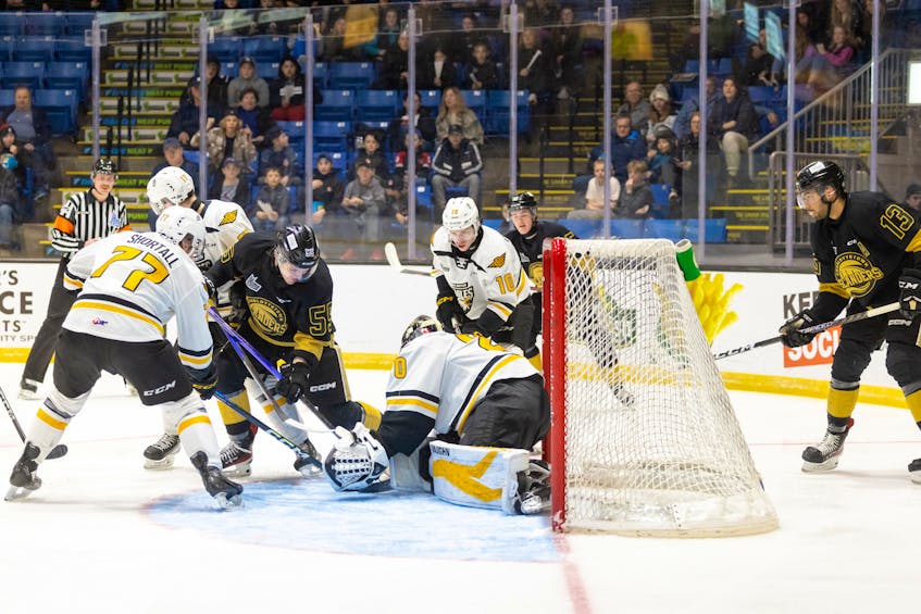 Charlottetown Islanders forward Simon Hughes, 55, of Stratford attempts to jam home a rebound on Cape Breton Eagles goaltender Oliver Satny during a Quebec Major Junior Hockey League (QMJHL) game at Eastlink Centre in Charlottetown on March 15. The Islanders won the game 3-1. Darrell Theriault Photo • Courtesy of Charlottetown Islanders