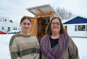 Mairéad MacInnis, left, and her mother Maureen MacInnis in front of the Community Pantry and Free Little Library in Lawrencetown. The two are among the many people who keep the tiny food bank stocked. 
Lawrence Powell