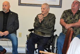Emmett O'Conner, centre, claps enthusiastically during the affordable housing funding announcement in Sydney Mines on March 17. Next to him are CBRM Dist. 1 Coun. Gordon MacDonald, left, and Ronnie Dauphniee. NICOLE SULLIVAN / CAPE BRETON POST