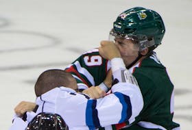 Halifax Mooseheads' Brandon Vuic (right) is punched by Chicoutimi Sagueneens' Reid Halabi (left) during their QMJHL hockey game in Halifax, September 26, 2014. (ADRIEN VECZAN/Staff)