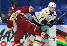 Cape Breton Eagles' Jacob Newcombe, right, looks to escape from Acadie-Bathurst Titan's Joseph Henneberry during their QMJHL game Saturday night at Centre 200 — the final regular-season home game for the Eagles. CONTRIBUTED/MIKE SULLIVAN