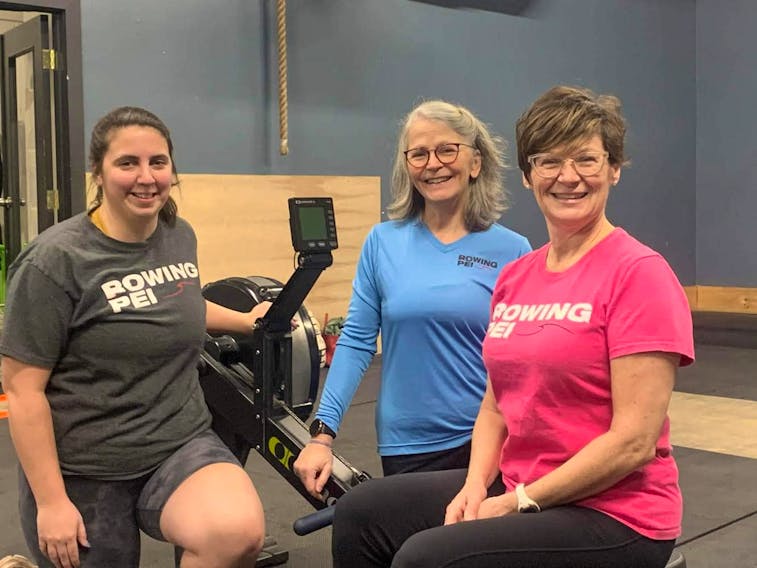 Three avid rowers from P.E.I. – Cassidy Doucette, Mary MacLean, and Chrissy Blanchard – are working out using indoor rowing machines to prepare for the 2023 World Rowing Masters Regatta in South Africa in early fall. The trio is training for the regatta as part of Oars East, a group of 17 rowers from P.E.I. and New Brunswick that will be competing at the World Masters Regatta. - Rowing P.E.I./Facebook