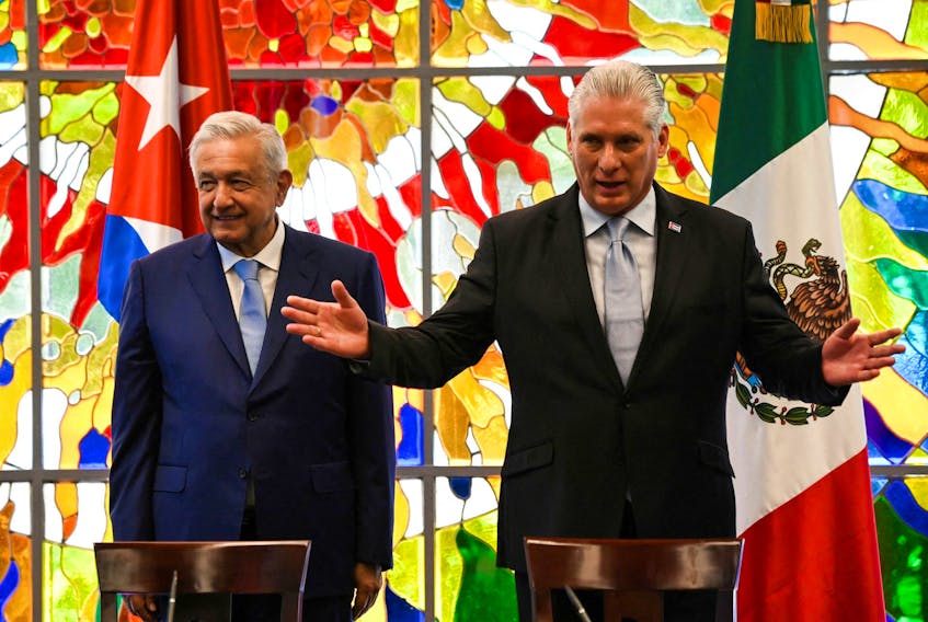 Mexico's President Andres Manuel Lopez Obrador and Cuba's President Miguel Diaz-Canel react during a ceremony at the Revolution Palace in Havana, Cuba, May 8, 2022. Yamil Lage/Pool via REUTERS
