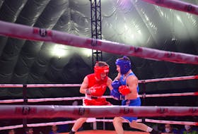 P.E.I.’s Matthew Mahood, left, and Quebec’s Jeremy Drapeau exchange punches during a featherweight (57kg) boxing match at the 2023 Canada Winter Games in Summerside on March 2. Drapeau, who is with Team Quebec, won by split decision Jason Simmonds • The Guardian