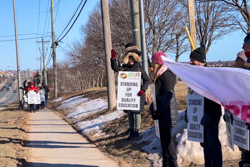 Striking faculty at the University of Prince Edward Island picket along University Avenue in Charlottetown Monday, March 20. Cody McEachern • The Guardian