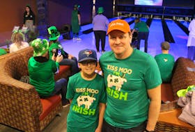 Quintin Annema, left, and his dad Sidney Annema enjoy a morning of bowling with the Cows Creamery group at the Bowl for Kids Sake fundraiser on March 18. This year's event featured a St. Patrick's Day theme. George Melitides • The Guardian