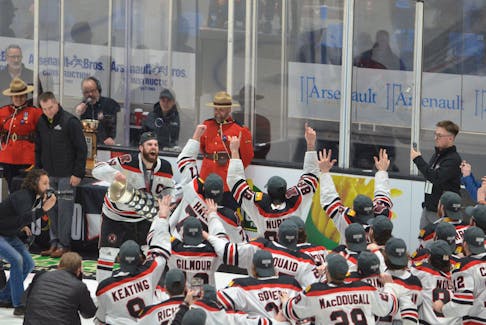 UNB Reds forward and team captain Jason Willms brings the Cavendish Farms University Cup back to his teammates after accepting the trophy at Eastlink Centre in Charlottetown on March 19. The Reds blanked the Alberta Golden Bears 3-0 in the final. The Reds have won eight national championships in the last 16 years – all under head coach Gardiner MacDougall of Bedeque. Jason Simmonds • The Guardian