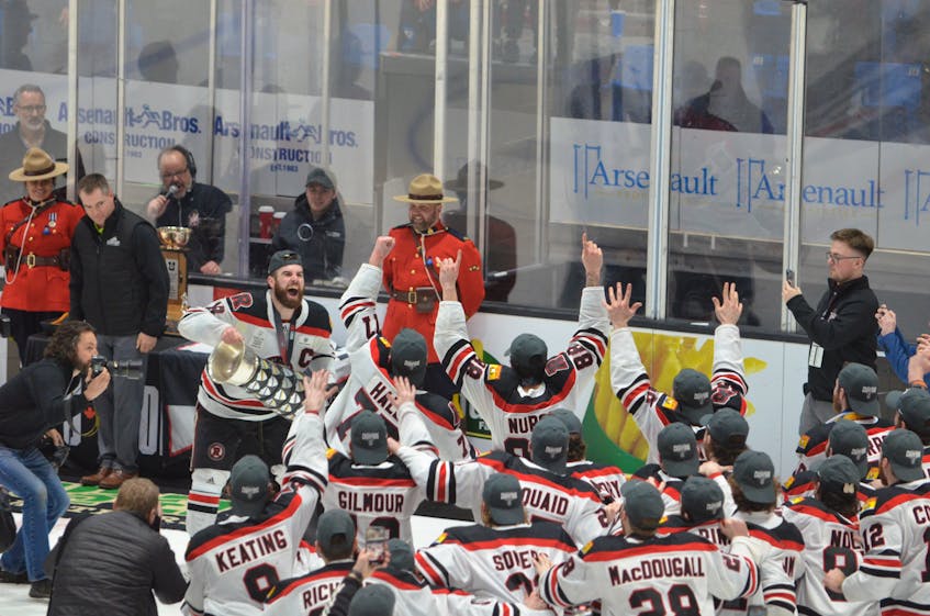 UNB Reds forward and team captain Jason Willms brings the Cavendish Farms University Cup back to his teammates after accepting the trophy at Eastlink Centre in Charlottetown on March 19. The Reds blanked the Alberta Golden Bears 3-0 in the final. The Reds have won eight national championships in the last 16 years – all under head coach Gardiner MacDougall of Bedeque. Jason Simmonds • The Guardian
