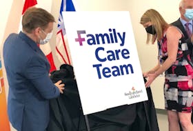 Premier Andrew Furey and Dr. Dianne Keating-Power unveil the province's new logo for family care teams Tuesday, March 21, in St. John's. At rear is Health Minister Tom Osborne. Peter Jackson • The Telegram