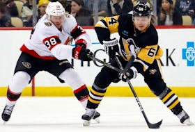 Pittsburgh Penguins centre Mikael Granlund (64) moves the puck against pressure from Ottawa Senators centre Patrick Brown (38) during the second period at PPG Paints Arena. 