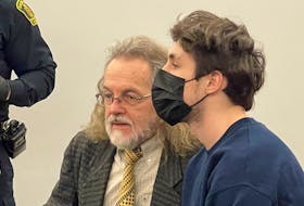 18-year-old Tyler Greening sits next to his lawyer, Bob Buckingham, in provincial court in St. John's Friday, March 17.
