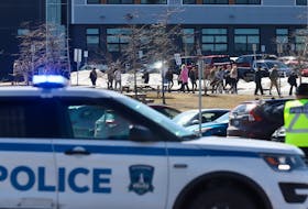 Halifax regional police officer looks on as students leaves CP Allen high school following a weapons complaint with injuries in Bedford March 20, 2023

TIM KROCHAK PHOTO