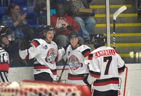 Ben Mercer, left, celebrates the first of his two goals during the Pictou County Crusher's home opener along with teammates Leyton Stewart and Venel Campbell. - FILE PHOTO