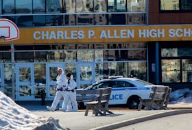 Members of the Halifax Regional Police forensics identification unit work at Charles P. Allen High School following a 'weapons complaint' with injuries in Bedford on March 20, 2023. 
TIM KROCHAK PHOTO