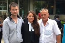 Britanny Whalen poses with her dad, Jack (right) and her brother, Nicholas as she celebrates her call to the bar in Ontario in 2016.