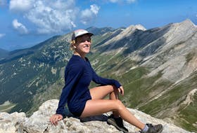 Lora Pope sits on the summit of a mountain in Bansko, Bulgaria. Contributed photo