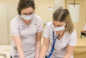 P.E.I. registered nurses Robyn Doran, left, and Megan Walsh look over some paperwork in 2021. There is a long list of health professionals who have seen P.E.I. through crises and need to be appreciated.