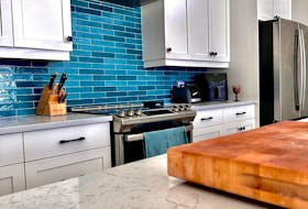 Damien Packwood of Charlottetown, P.E.I. creates an eye-catching bright blue kitchen backsplash that injects the much-needed colour into a neutral space. Contributed photo
