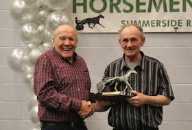 Phil Sizer, left, is the recipient for the Horseman of the Year, which was handed to him by George Riley at the annual Prince County Horsemen's Club awards banquet. Logan Plant