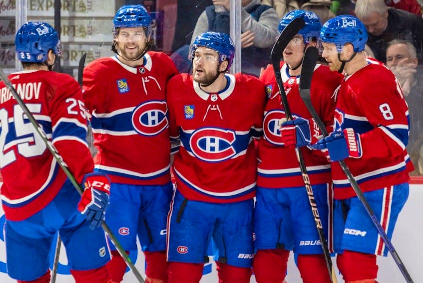 Canadiens' Jonathan Drouin, centre, celebrates his goal with teammates during a win over the Lightning Tuesday at the Bell Centre. Former GM Serge Savard has been impressed with how the injury-ravaged Habs have been competitive this season.