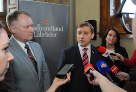 Premier Andrew Furey, flanked by Transportation Minister Elvis Loveless and Finance Minister Siobhan Coady, answers reporters' questions on Wednesday, March 22. -Joe Gibbons/The Telegram