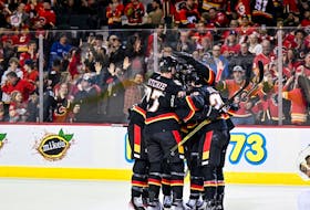 Mar 23, 2023; Calgary, Alberta, CAN; Calgary Flames center Nazem Kadri (91) celebrates with teammates after scoring a goal against the Vegas Golden Knights during the third period at Scotiabank Saddledome. Mandatory Credit: Brett Holmes-USA TODAY Sports