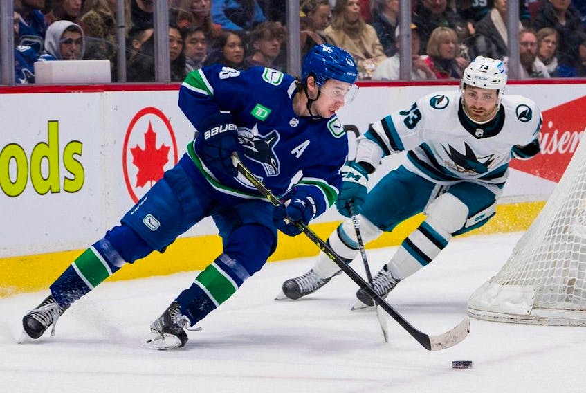  Vancouver Canucks defenceman Quinn Hughes (43) moves the puck against San Jose Sharks forward Noah Gregor (73) in the second period at Rogers Arena.