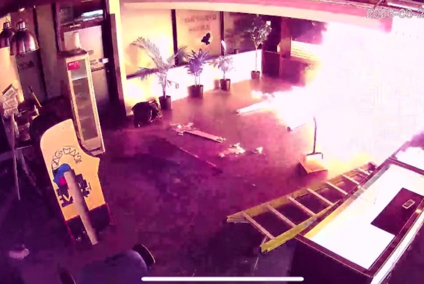 A screenshot from a security video showing Exotic Munchies being firebombed on Tuesday night.