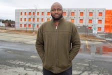 Chukwuemeka Ugwu, an international student from Nigeria, poses for a photo in front of some student housing under construction at NSCC's Akerley Campus on Friday, March 24, 2023.
Ryan Taplin - The Chronicle Herald