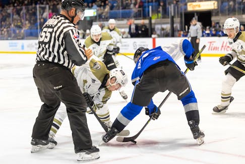 Charlottetown Islanders forward and team captain Keiran Gallant, left, of Covehead takes a faceoff against the Saint John Sea Dogs’ Cole Burbidge in a Quebec Major Junior Hockey League game at Eastlink Centre in Charlottetown on March 24. The Islanders won the game 4-3 in overtime. Darrell Theriault Photo • Courtesy of Charlottetown Islanders