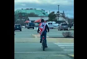 Bridgewater Police Service is investigating reports of a man riding a bicycle in the town while wearing a swastika flag on Friday, March 24. Screenshot