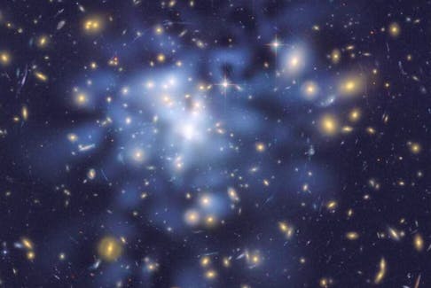 An image from the Hubble telescope shows inferred dark matter in a galactic cluster tinted blue. Scientists have proposed that a second big bang created such exotic matter.