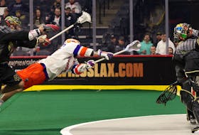 Colton Armstrong of the Halifax Thunderbirds goes airborne against Philadelphia Wings netminder Angus Goodleaf in NLL action Saturday night in Philadelphia. - NATIONAL LACROSSE LEAGUE